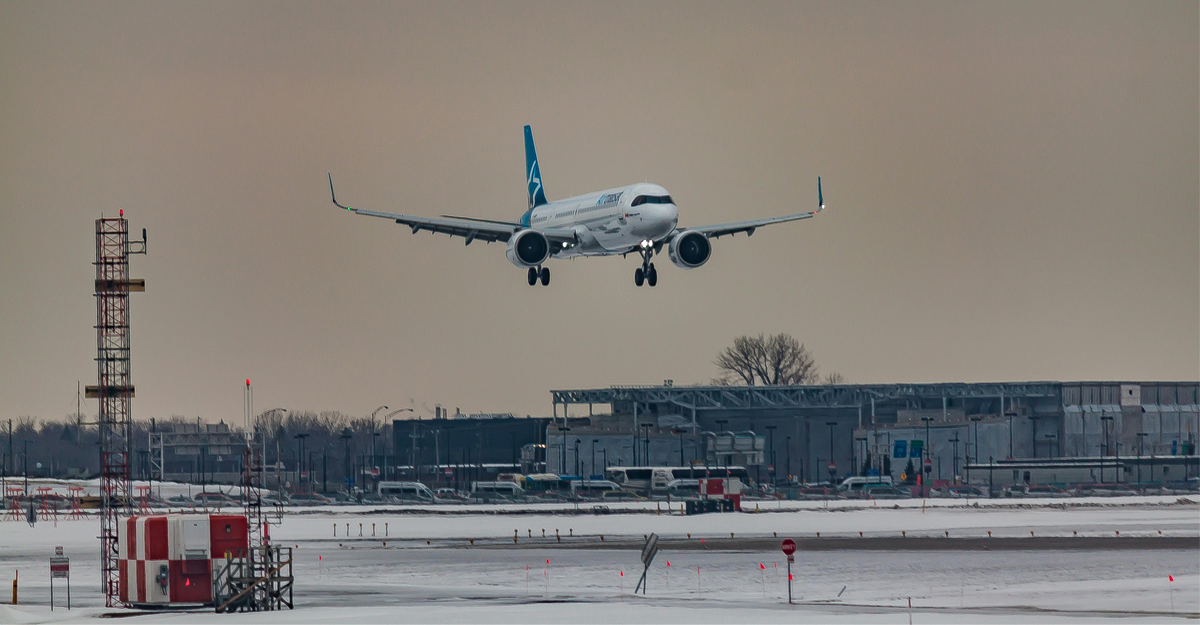 aeroplane preparing to land in snowy airfield