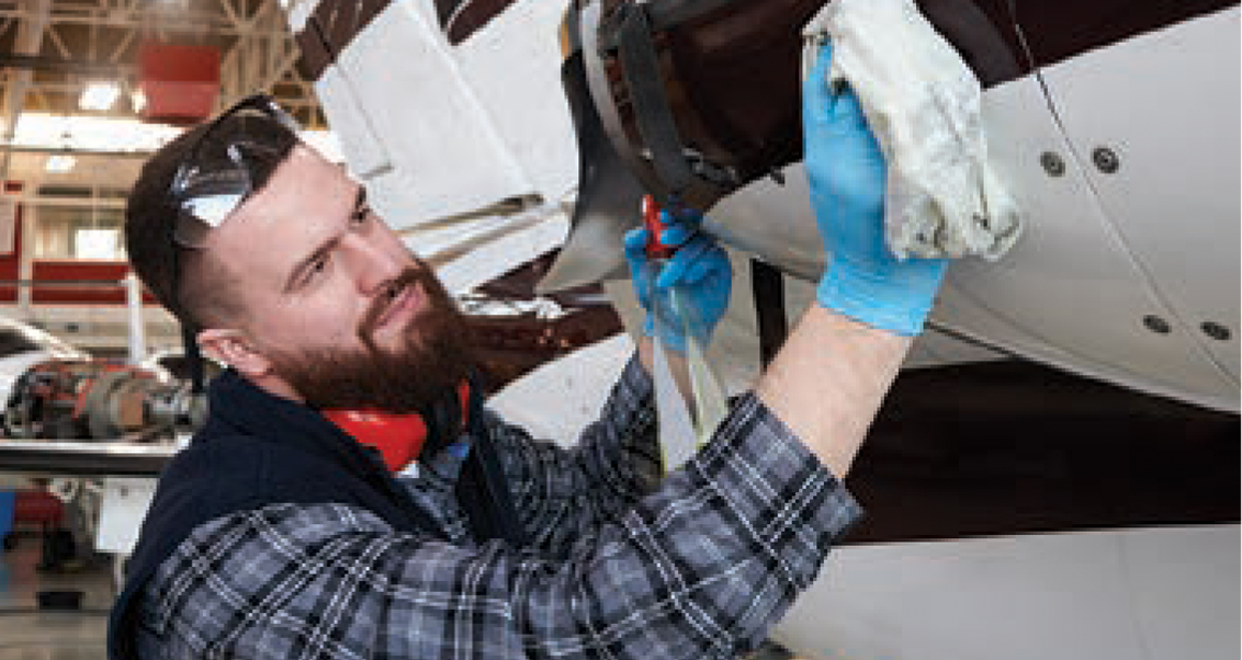 man cleaning aeroplane